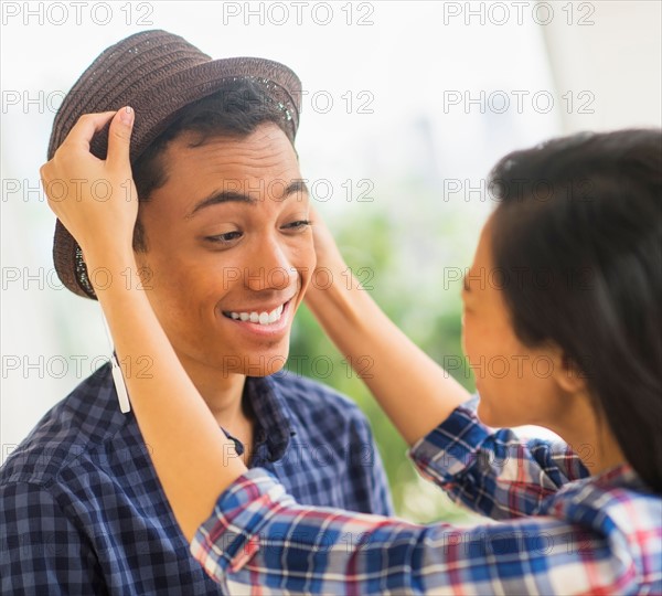 Young man trying on hat