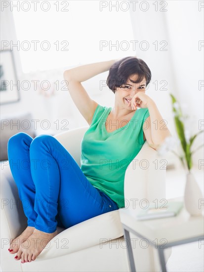 Portrait of cheerful woman relaxing at home