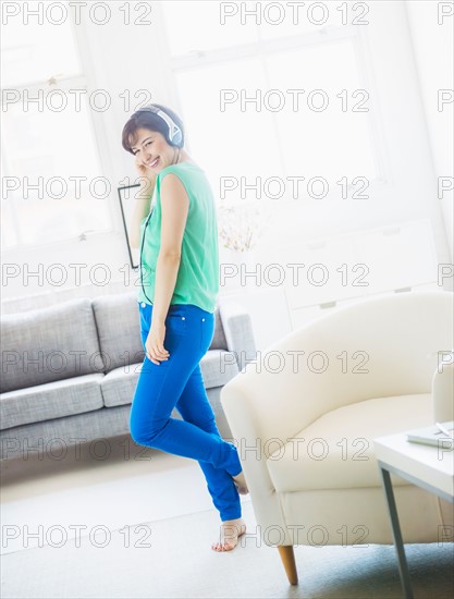 Young woman listening to music at home