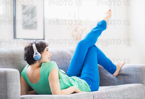 Young woman listening to music at home