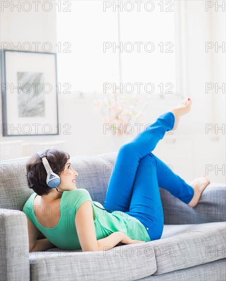 Young woman listening to music at home