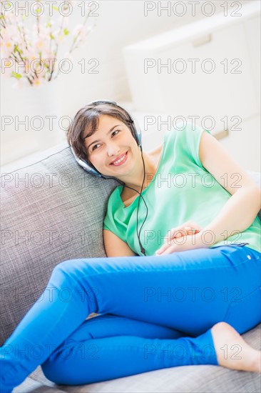 Young woman listening to music at home