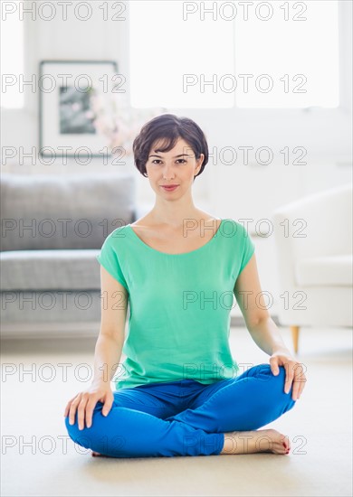 Young woman sitting on floor