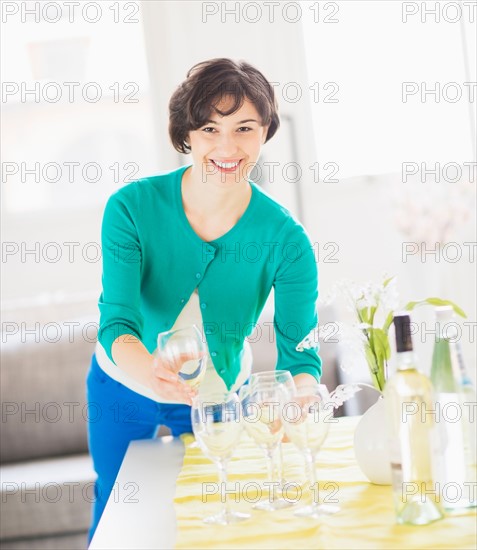 Woman setting table at home