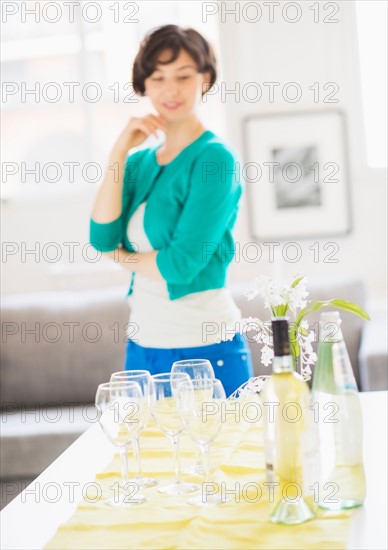 Woman standing behind table at home