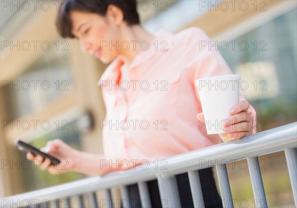 Portrait of business woman text messaging
