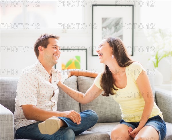 Portrait of playful couple on sofa