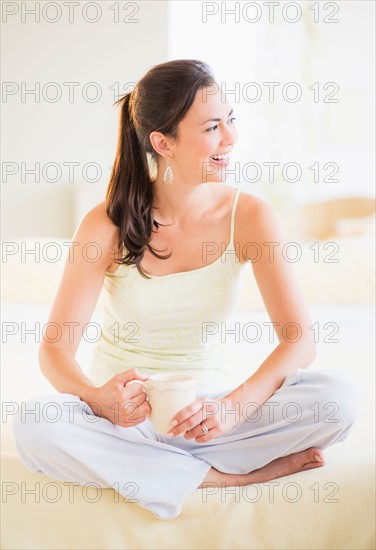 Portrait of woman relaxing in bedroom