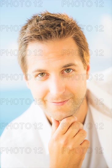 Studio Shot of handsome man with hand on chin