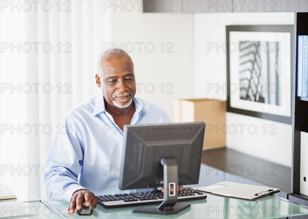 Portrait of senior man working on computer in office