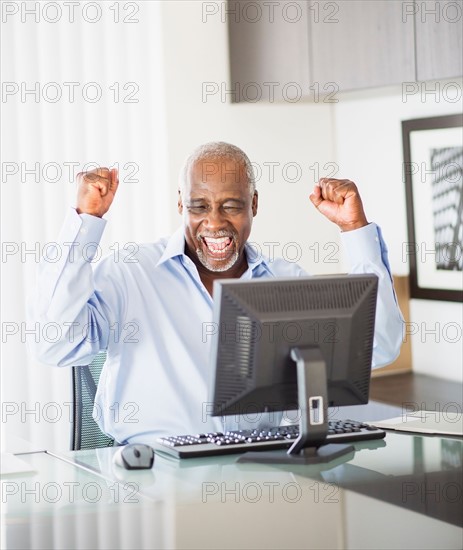 Portrait of satisfied senior man in office