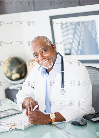 Portrait of doctor writing prescription