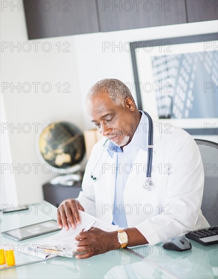 Portrait of doctor holding prescription