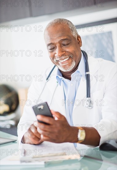 Portrait of doctor text messaging