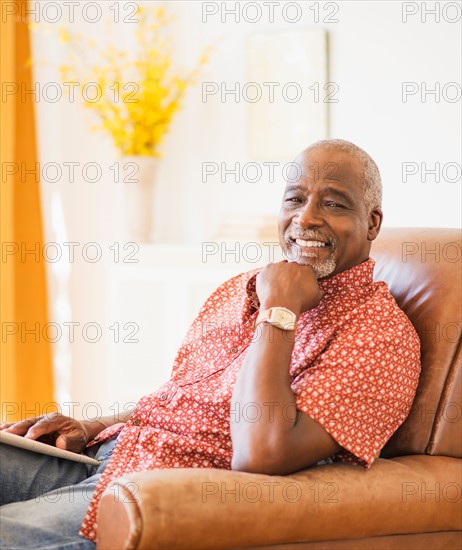 Portrait of men sitting in armchair