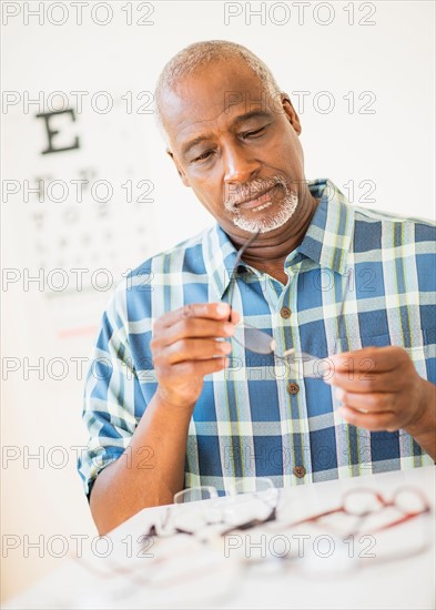 Man looking at glasses in store