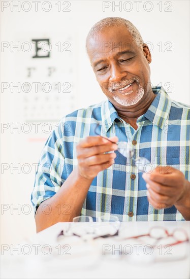 Man looking at glasses in store