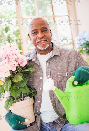 Portrait of man working in greenhouse