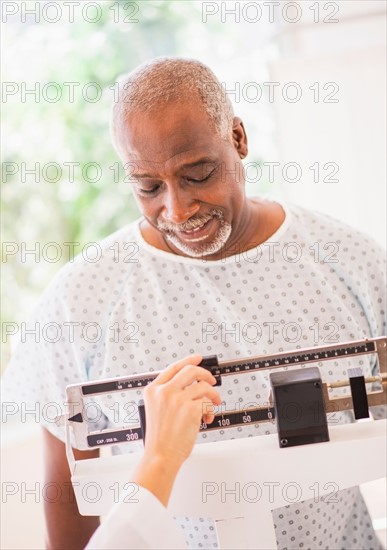 Portrait of man standing on weight scale