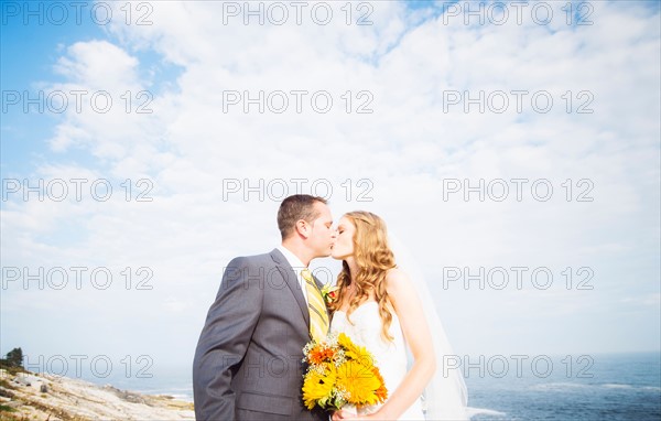 Portrait of married couple kissing