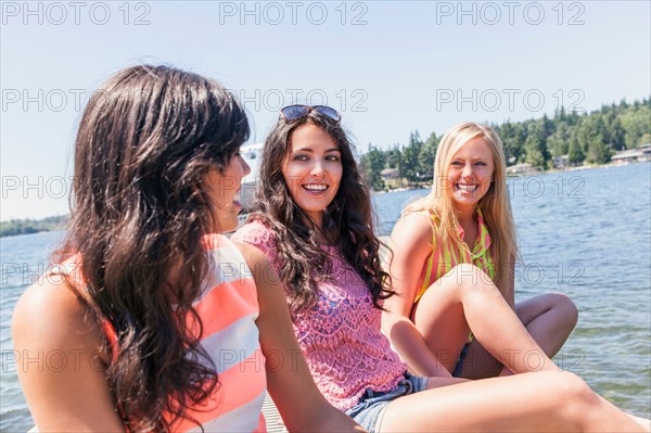 Young women hanging out by lake