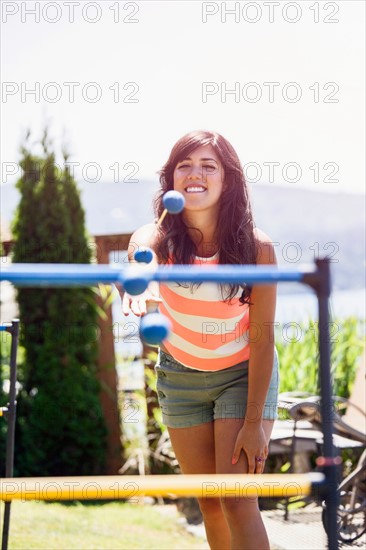 Portrait of young woman throwing balls