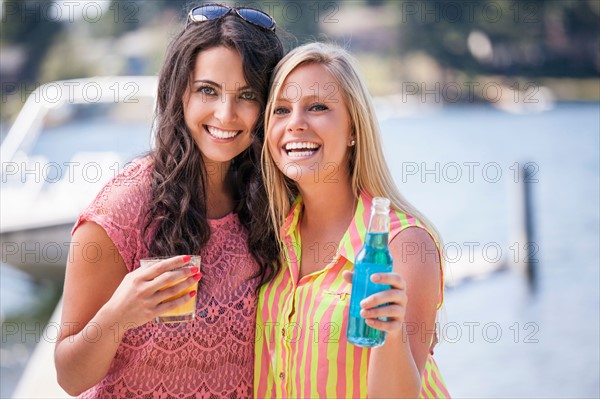 Portrait of young women posing with drinks