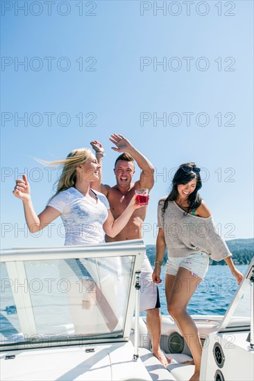 Young people having fun on motorboat