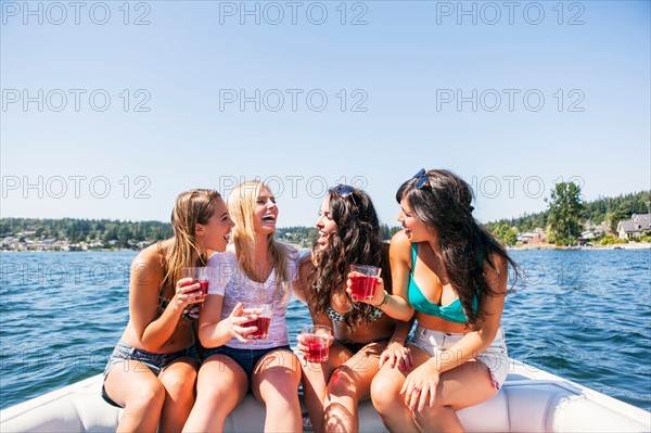 Young women having fun on motorboat