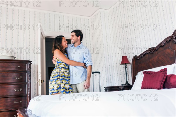 Young couple embracing in hotel room