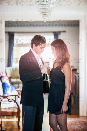 Young elegant couple drinking wine