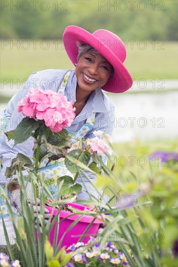 Portrait of senior woman working in garden