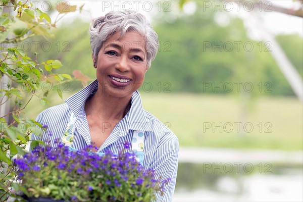 Portrait of senior woman working in garden