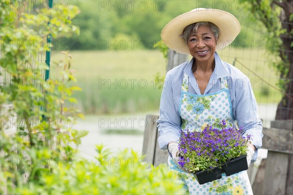 Portrait of senior woman working in garden