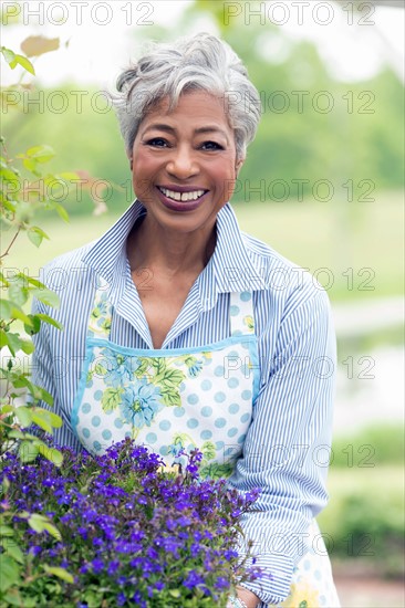 Portrait of senior woman working in garden