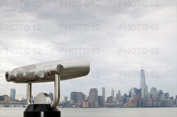 View of city with coin operated binocular in foreground