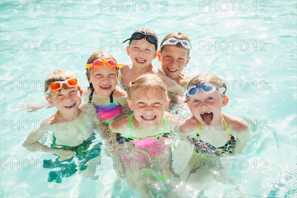 Children (4-5, 2-3, 8-9, 10-11, 18-23 months) playing in swimming pool