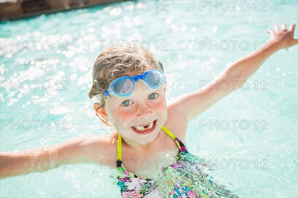 Girl (4-5) playing in swimming pool