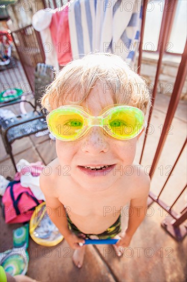 Boy (4-5) posing in swimming goggles