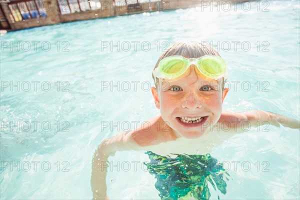 Boy (4-5) posing in swimming pool