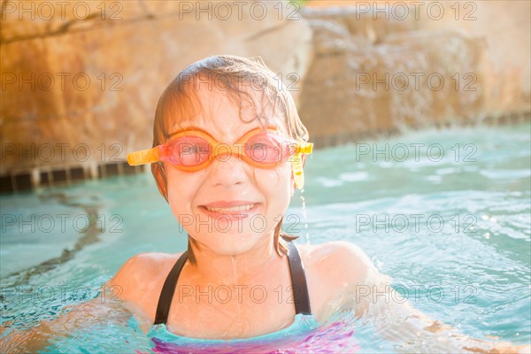 Girl (8-9) playing in swimming pool