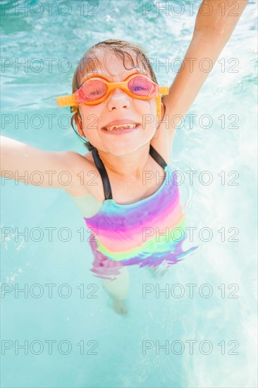 Girl (8-9) playing in swimming pool