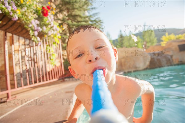 Boy (4-5) posing in swimming pool