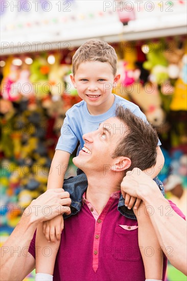 Happy father with son (4-5) in amusement park