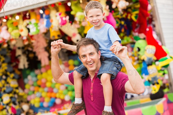 Happy father with son (4-5) in amusement park