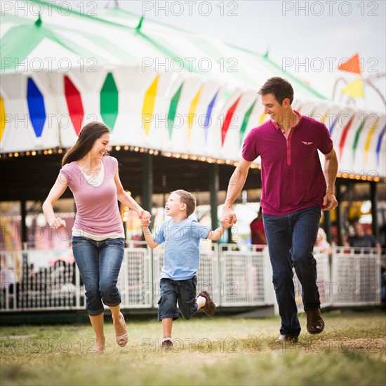 Happy Family and son (4-5) in amusement park