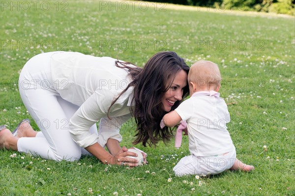 Mother and daughter (12-17 months) playing in park