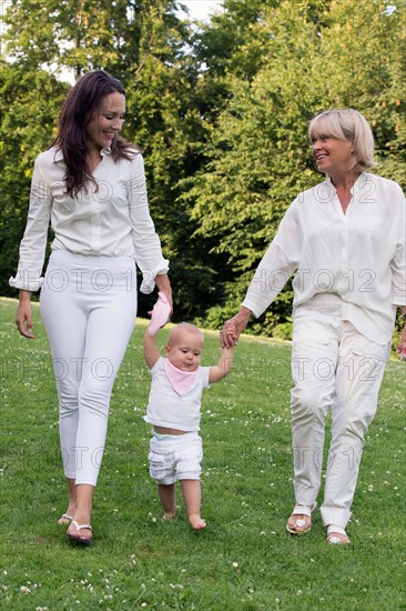 Three generation family walking in park