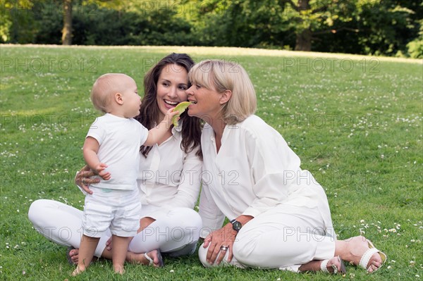 Three generation family playing in park