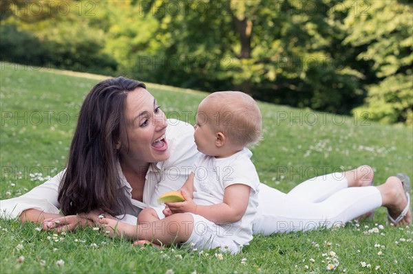 Mother and daughter (12-17 months) playing in park